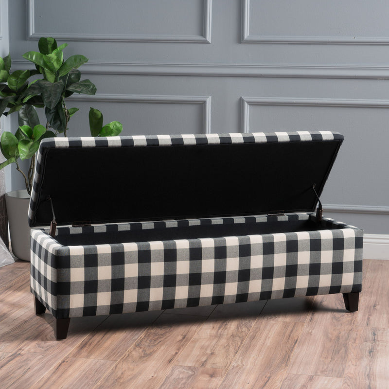 Black Noble House contemporary storage ottoman with cushioned seating and spacious storage compartment.