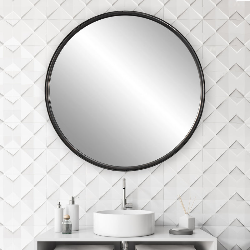 Uttermost Dawsyn round black accent mirror with sleek frame, hanging on a wall in modern decor setting.