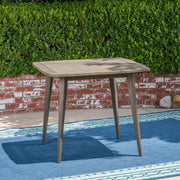 Modern indoor square dining table by Noble House with acacia wood surface and toothpick leg design, perfect for contemporary dining rooms.