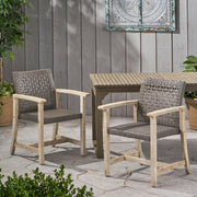 Set of two Noble House outdoor dining chairs with acacia wood frames, featuring slatted seats and backrests for garden or patio use.