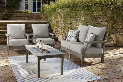 Signature Design by Ashley Visola lounge set, a 4-piece outdoor furniture set with cushioned chairs and a table, ideal for outdoor relaxation.