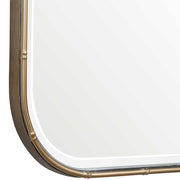 Uttermost Malay gold vanity mirror with a sleek, round design and a stylish frame, ideal for bedroom or bathroom decor.