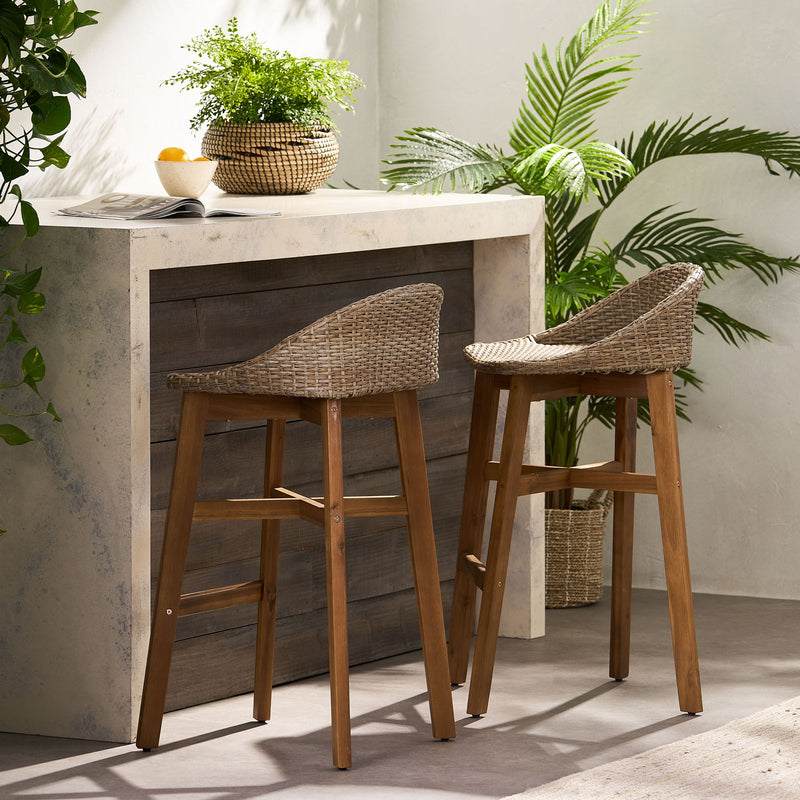 Set of two Noble House Beeson outdoor wicker and acacia wood barstools, water-resistant brown stools with a stylish design.