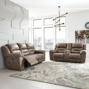Signature Design by Ashley reclining sofa from Stoneland collection featuring plush cushions and a modern reclining design.