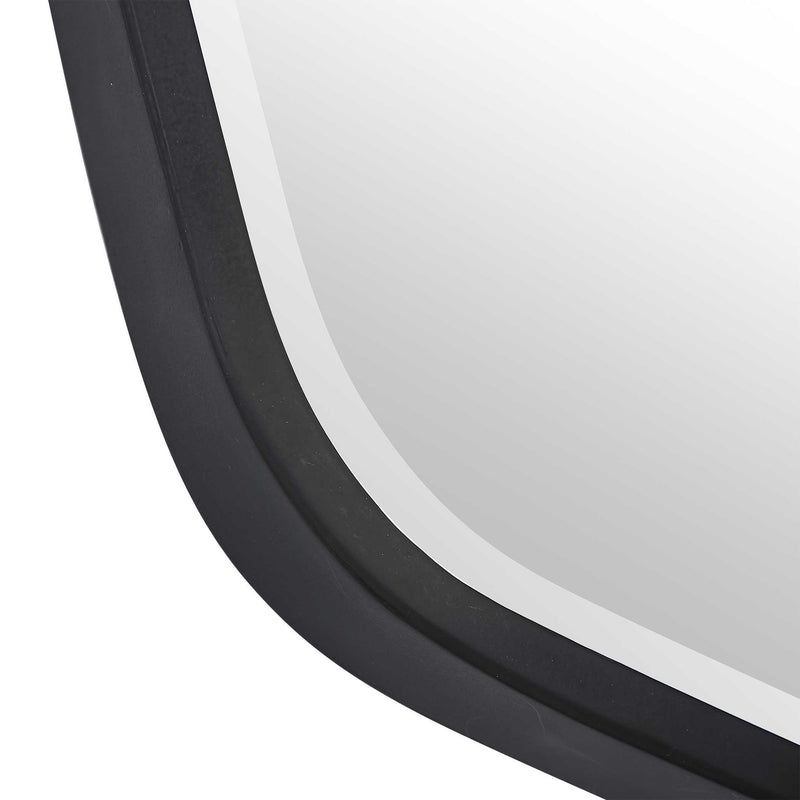 Uttermost Duronia iron wall mirror with a sleek, modern frame reflecting light and enhancing interior decor.