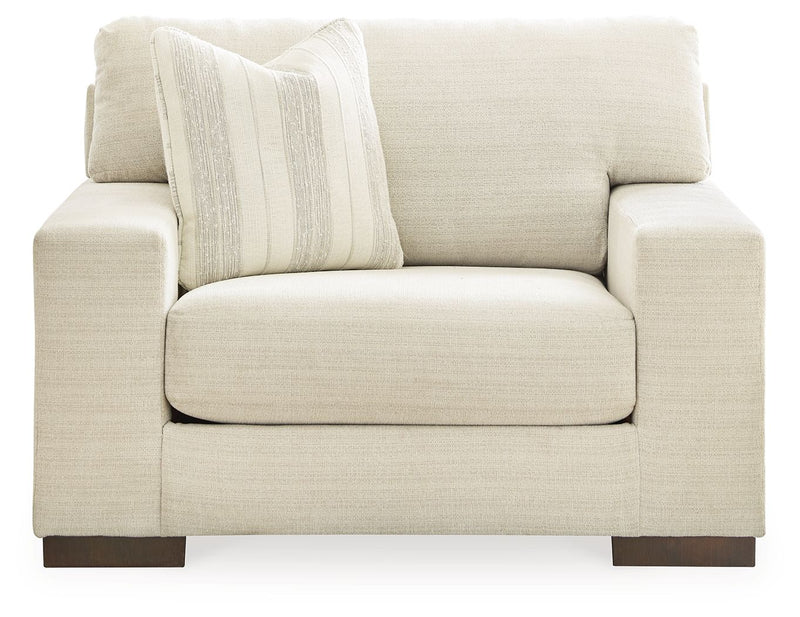 Signature Design by Ashley Maggie living room set with a stationary chair and ottoman in a cozy, modern living space.