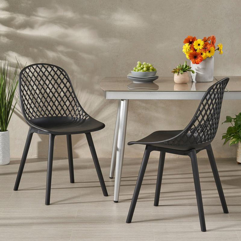 Set of two Noble House Lily chairs with sleek wooden legs and cushioned seats, perfect for modern dining or living spaces.