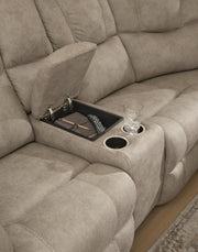 Signature Design by Ashley Pearce-Pike reclining sectional with plush cushions and reclining features, shown in a modern living room setting.