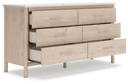Six-drawer dresser from Signature Design by Ashley, featuring a sleek wood finish and modern hardware for stylish bedroom storage.