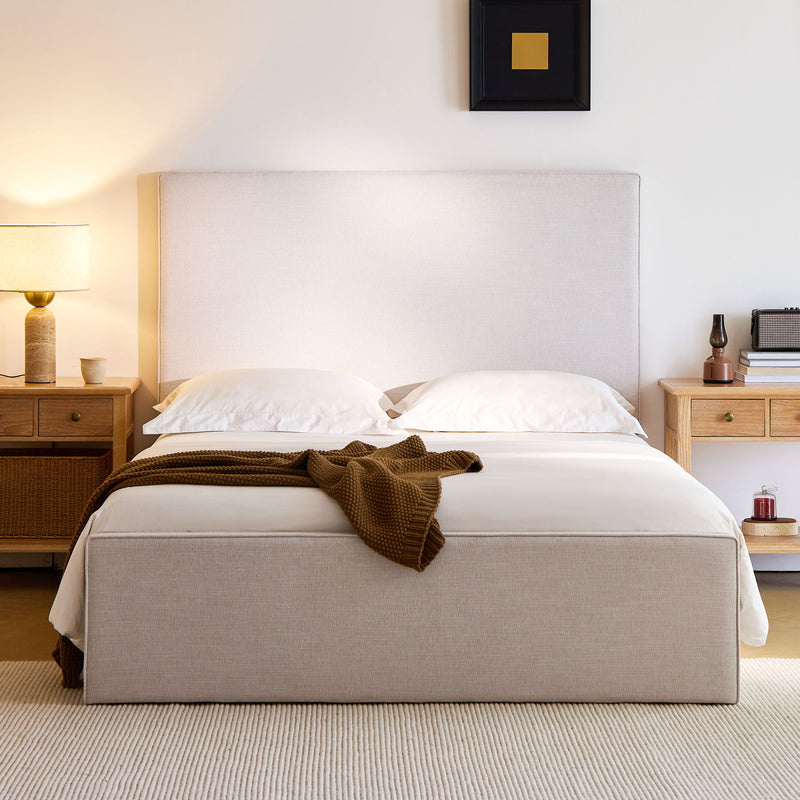 House & Home Furniture Lucas tall upholstered bed headboard with padded fabric and sleek design, shown in a modern bedroom setting.