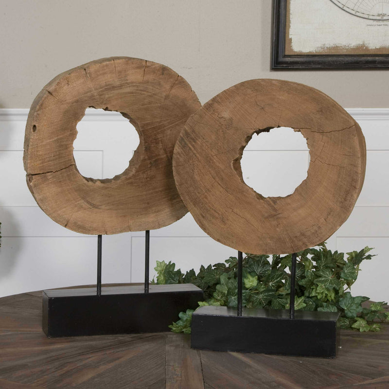 Pair of Ashlea wooden sculptures by Uttermost, featuring light brown and black finishes, displayed as decorative figurines.