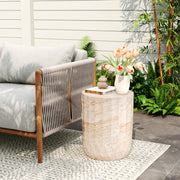 Beige lightweight concrete side table with cylinder shape and travertine finish, suitable for outdoor or indoor use by Noble House.