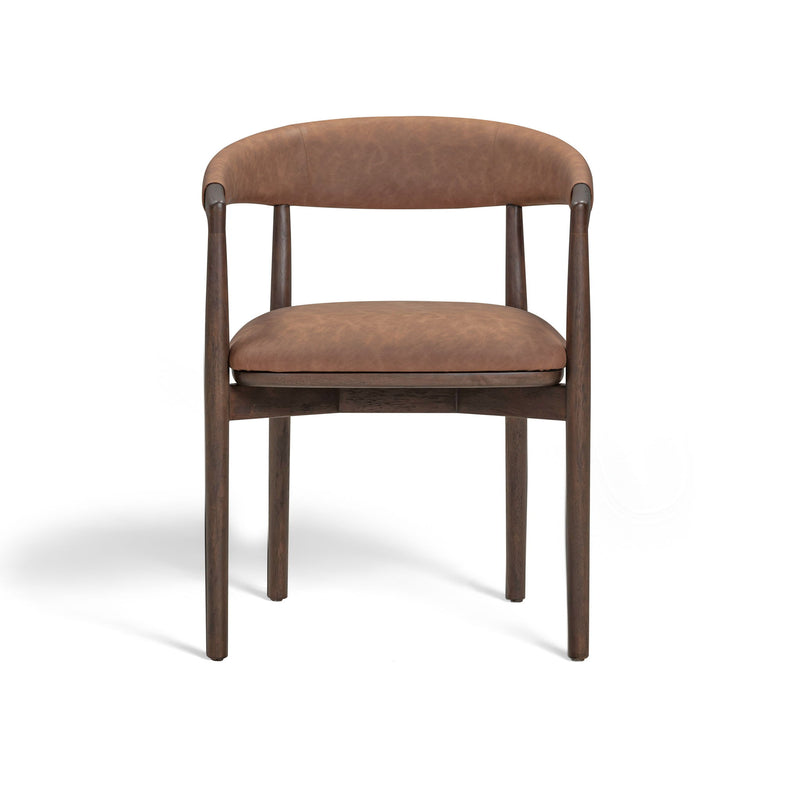Vina vegan leather dining arm chair by TOV Furniture with sleek modern design and cushioned seat in a contemporary setting.