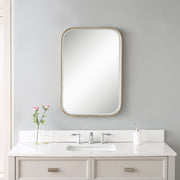 Gold Malay vanity mirror by Uttermost, round framed mirror with a sleek, reflective glass surface for elegant dressing space.