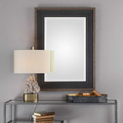 Uttermost Staveley Rustic Black Wall Mirror with a textured wooden frame and vintage-inspired design.