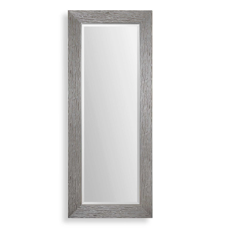 Large silver floor mirror by Uttermost, with a sleek, modern frame reflecting a spacious room.