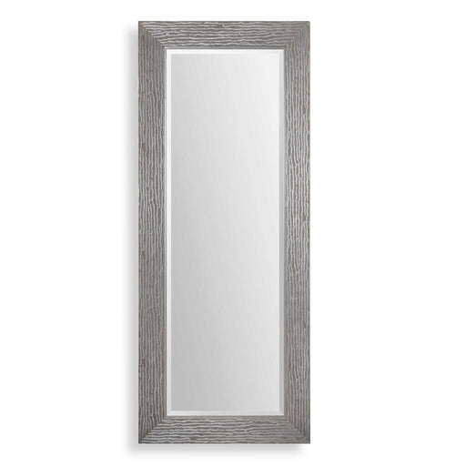 Large silver floor mirror by Uttermost, with a sleek, modern frame reflecting a spacious room.