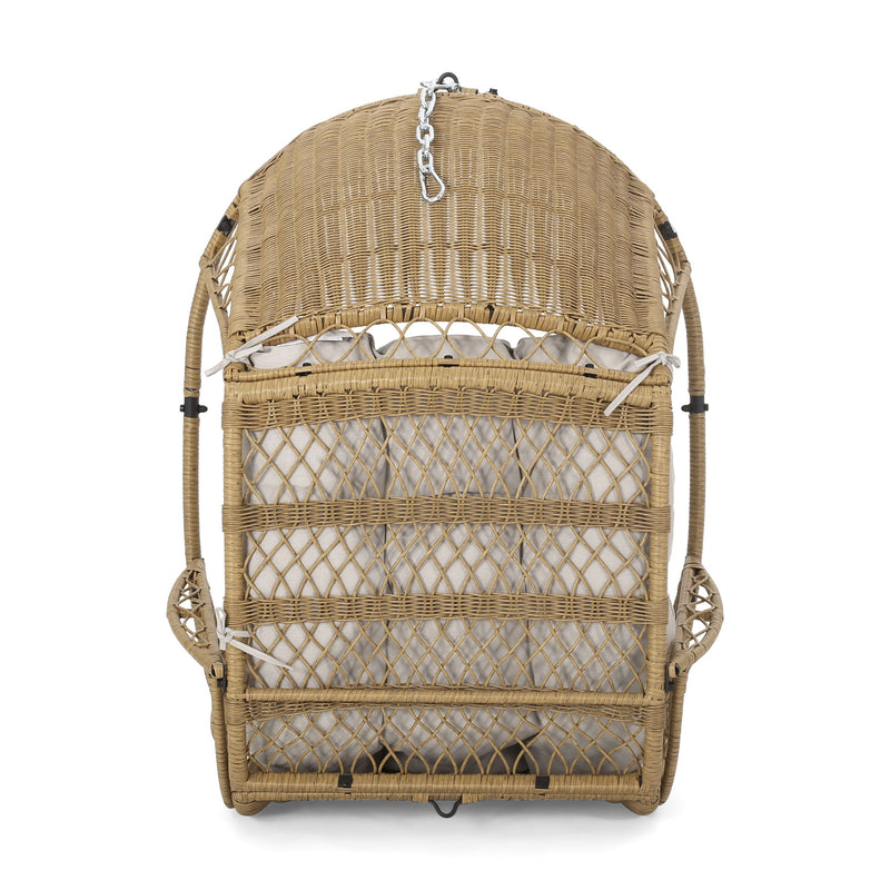 Wicker hanging chair with cushion from Noble House, ideal for relaxing indoors or outdoors in a cozy seating area.