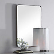 Silver wall mirror by Uttermost, Aramis design, featuring a sleek, modern frame with reflective glass surface.