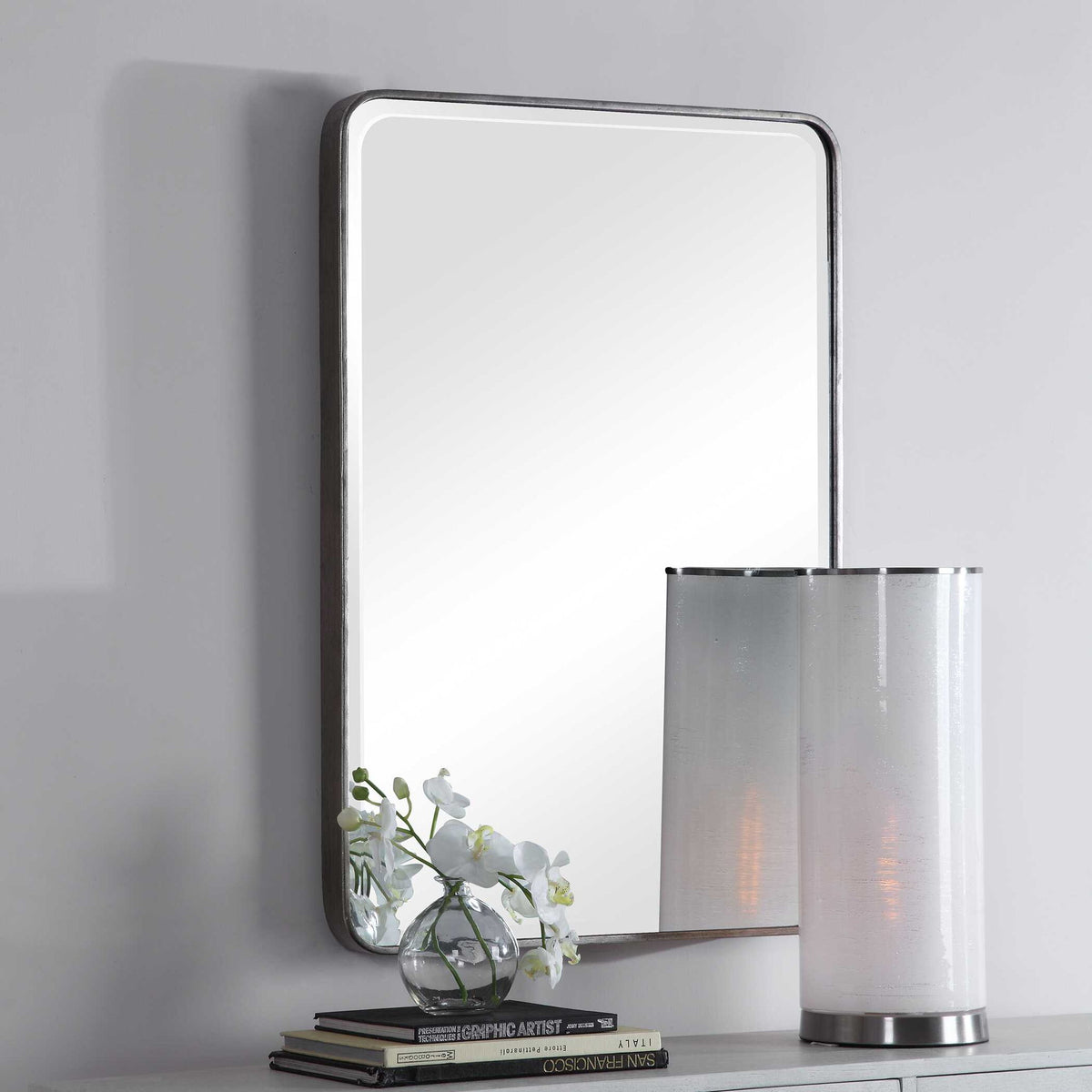 Silver wall mirror by Uttermost, Aramis design, featuring a sleek, modern frame with reflective glass surface.