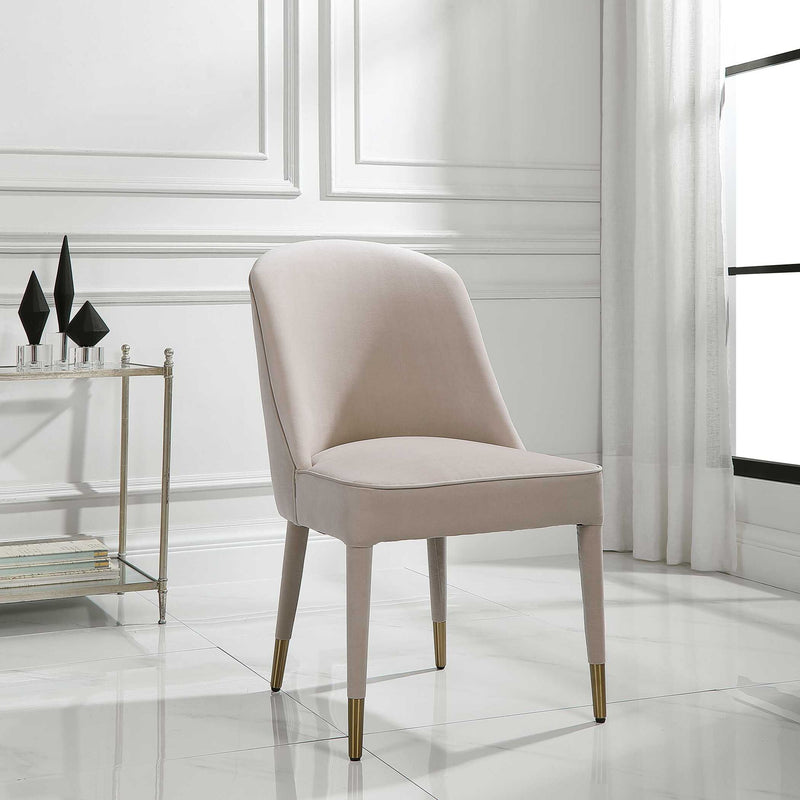 Set of two Uttermost Brie armless chairs with neutral upholstery and wooden legs, modern design for living or dining areas.