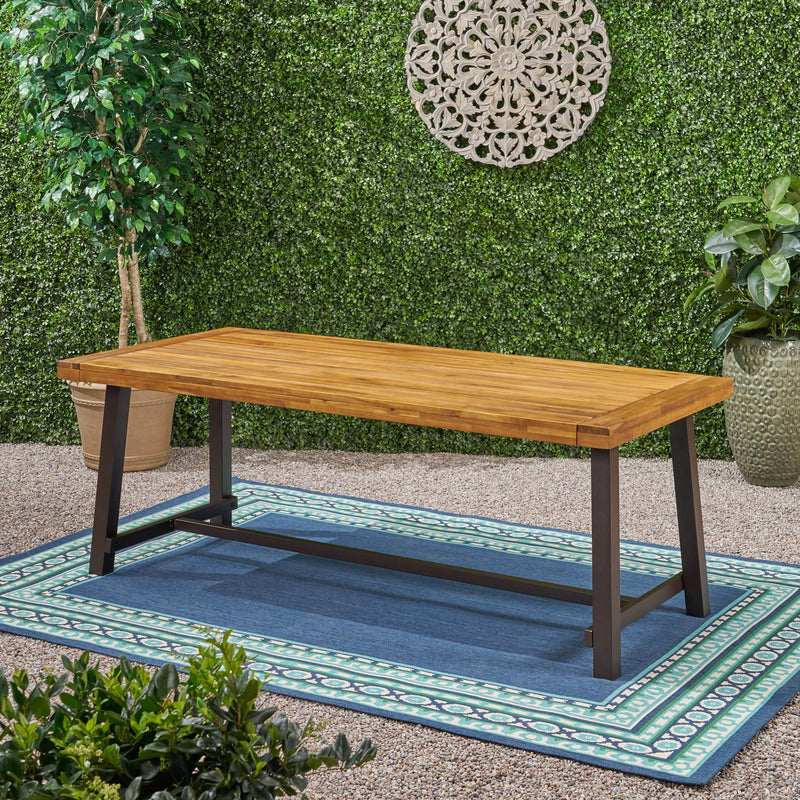 Noble House Equilibrium outdoor dining table with wooden frame and slat top, suitable for outdoor patio or garden dining spaces.