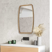 Gold Tiki accent mirror by Uttermost featuring a stylish Tiki design with a circular mirror and decorative gold frame.