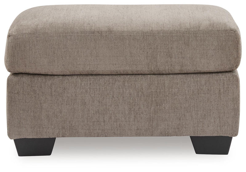 Benchcraft® upholstered Ottoman with a plush fabric finish, featuring a sturdy wooden frame and modern design.