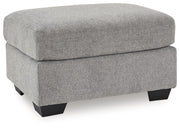 Benchcraft® upholstered Ottoman with plush fabric, featuring a rectangular shape and wooden legs for stylish comfort.