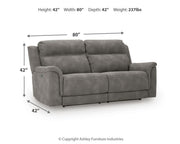 Signature Design by Ashley Durapella reclining power sofa with plush cushions and leather upholstery, shown in a modern living room setting.