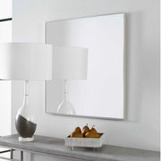 Uttermost Alexo square wall mirror with a sleek frame, reflecting interior decor and natural light.