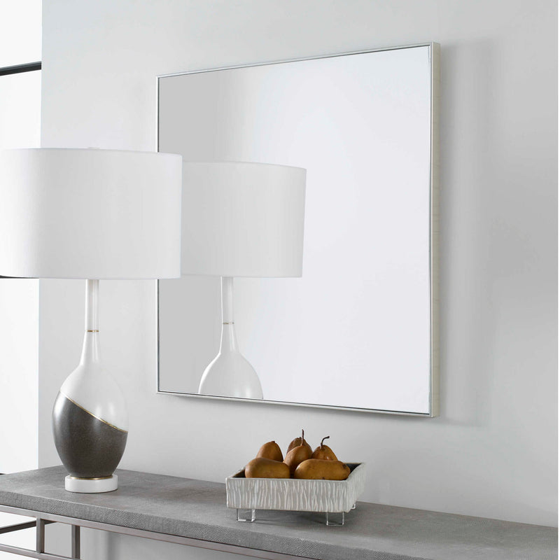 Uttermost Alexo square wall mirror with a sleek frame, reflecting interior decor and natural light.
