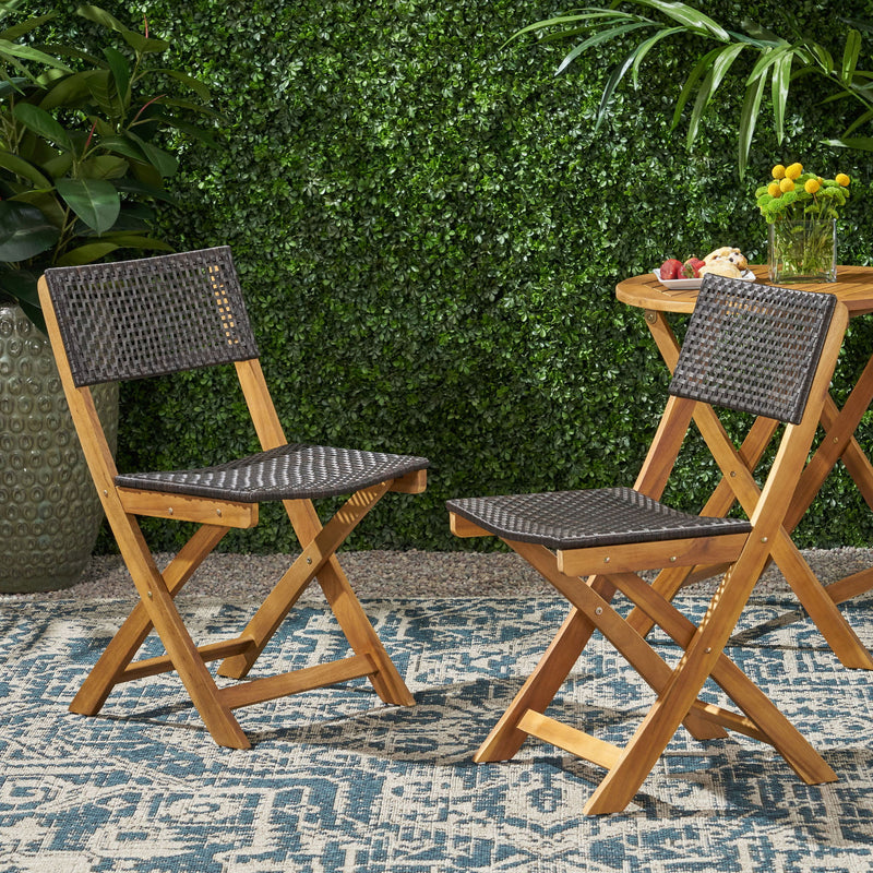 Noble House bistro foldable armless chair with wicker backrest and metal frame, shown in a stylish outdoor setting