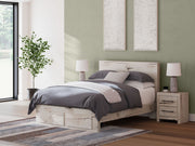 Signature Design by Ashley Lawroy panel bed with built-in storage drawers in a modern bedroom setting.
