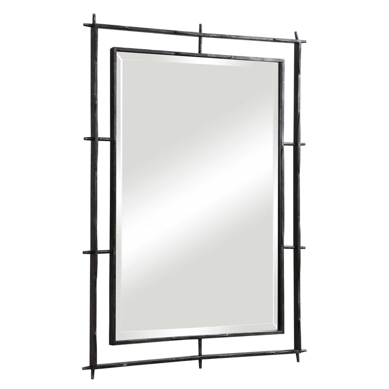 Industrial black wall mirror by Uttermost with a metal frame, perfect for modern or industrial decor styles.