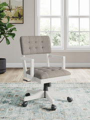 Robbinsdale home office desk chair in antique white with a cushioned seat and backrest, metal frame, and armrests.