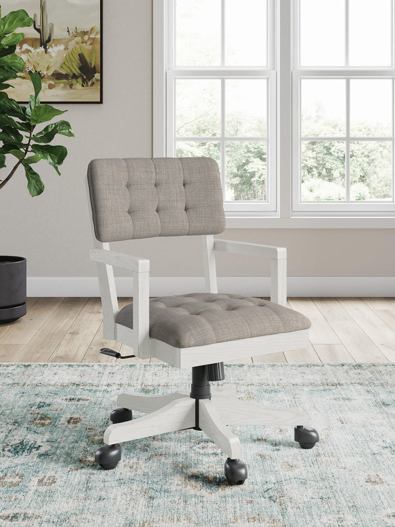 Robbinsdale home office desk chair in antique white with a cushioned seat and backrest, metal frame, and armrests.