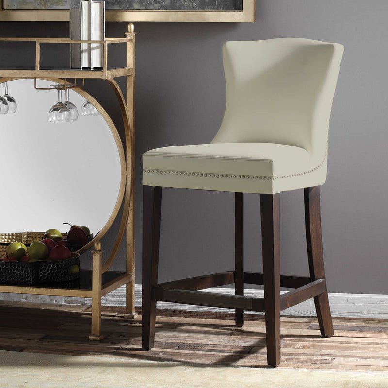 Uttermost Dariela white counter stool with modern design, 24-27 inch height, featuring sleek legs and cushioned seat.