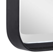 Uttermost Croften black vanity mirror with a sleek, modern design, reflecting a stylish bathroom or dressing area.