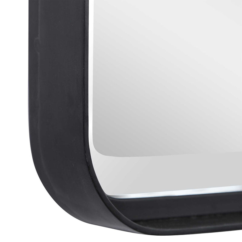 Uttermost Croften black vanity mirror with a sleek, modern design, reflecting a stylish bathroom or dressing area.