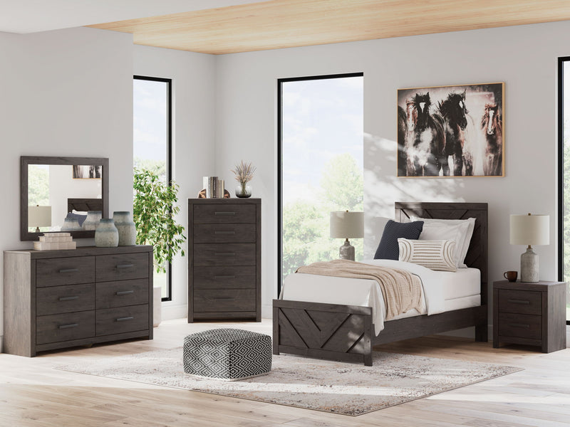Signature Design by Ashley Prendonea panel bedroom set featuring a bed, dresser, mirror, and two nightstands in a modern style.