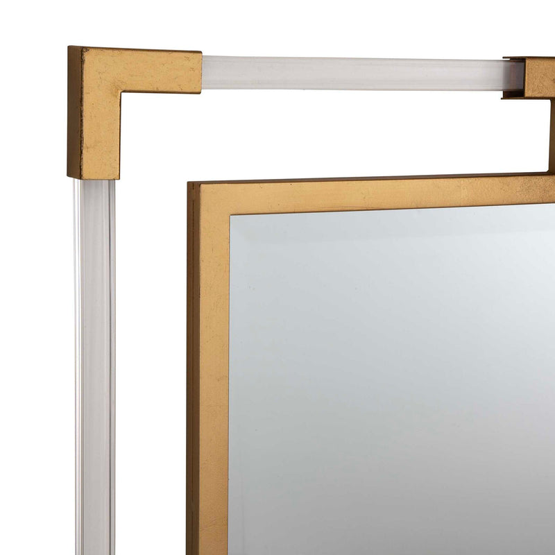 Uttermost Balkan iron wall mirror with a round, decorative metal frame reflecting light in a modern interior setting.