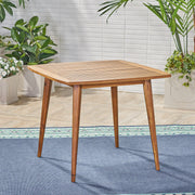 Modern indoor square dining table by Noble House with acacia wood surface and toothpick leg design, ideal for contemporary dining rooms.