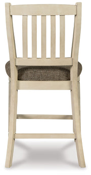 Set of two beige upholstered barstools from Signature Design by Ashley, featuring padded seats and sturdy wood legs.