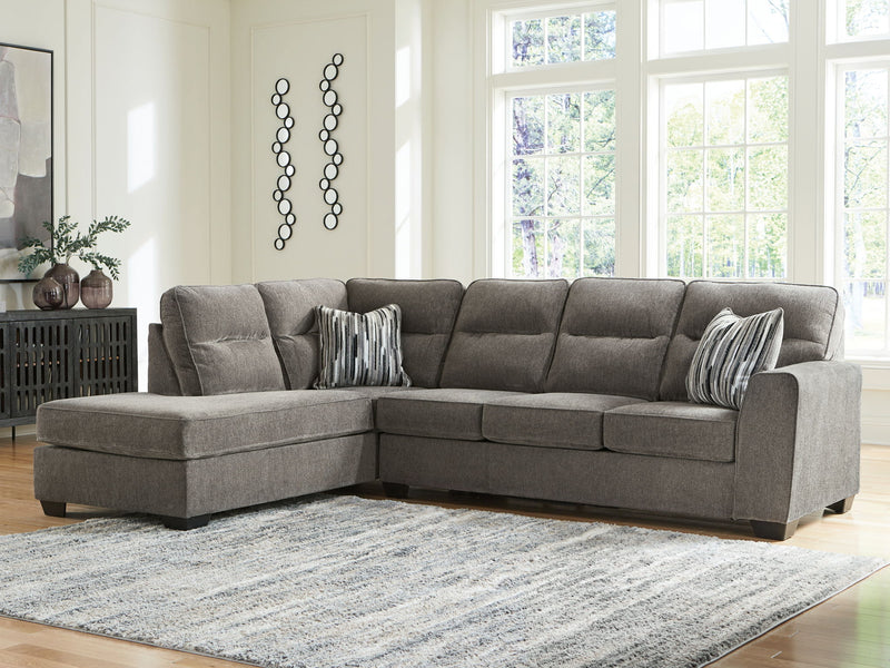 Benchcraft Olten Stationary Sectional sofa with plush cushions, neutral fabric, and modern design in a cozy living room setting.