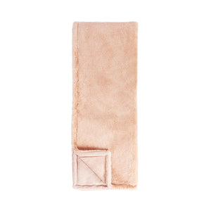 Soft beige Classic Home Taiga throw draped over a cozy armchair, showcasing its plush, textured fabric for added warmth and style.
