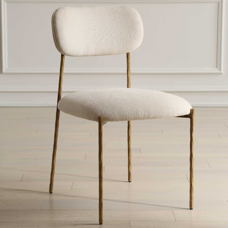 Set of two Capture dining chairs by Uttermost with gold finish and white upholstered seats, featuring a sleek modern design.