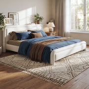 Artistry At Home upholstered platform bed frame with curved headboard and wood slats support, showcasing soft fabric upholstery and modern design.