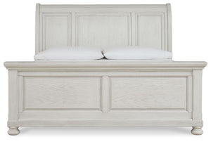 Robbinsdale Signature Design by Ashley sleigh storage bed with wooden finish and built-in under-bed storage drawers.