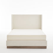 House & Home Furniture Hosford minimalist upholstered wingback bed with wood platform base, shown in a modern bedroom setting.